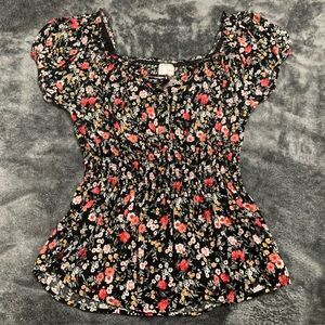 Black floral frilled top in the size small